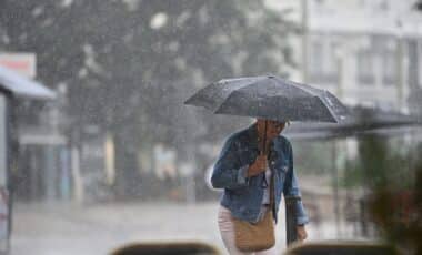 Météo pluvieuses illustrée par une personne avec un parapluie