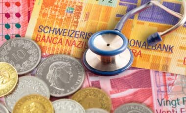 stéthoscope sur des billets et pièces de franc suisse