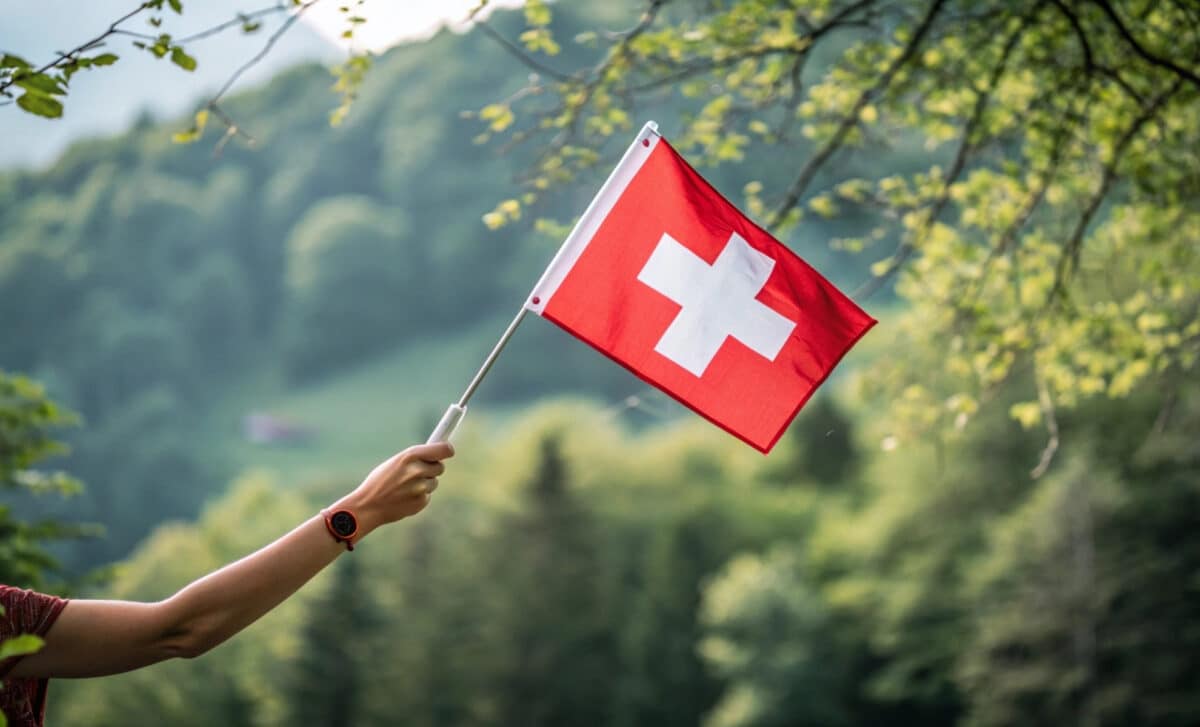 une personne tient un drapeau suisse