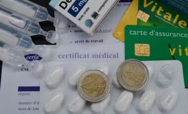 Photo regroupant des pièces d'argent, la carte vitale, des médicaments et un certificat médical pour évoquer les remboursements santé