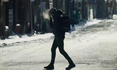 Un homme marchant sous une météo très froide