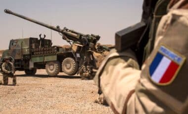 Des soldats de l’armée française en opération avec un canon Caesar déployé en zone aride.